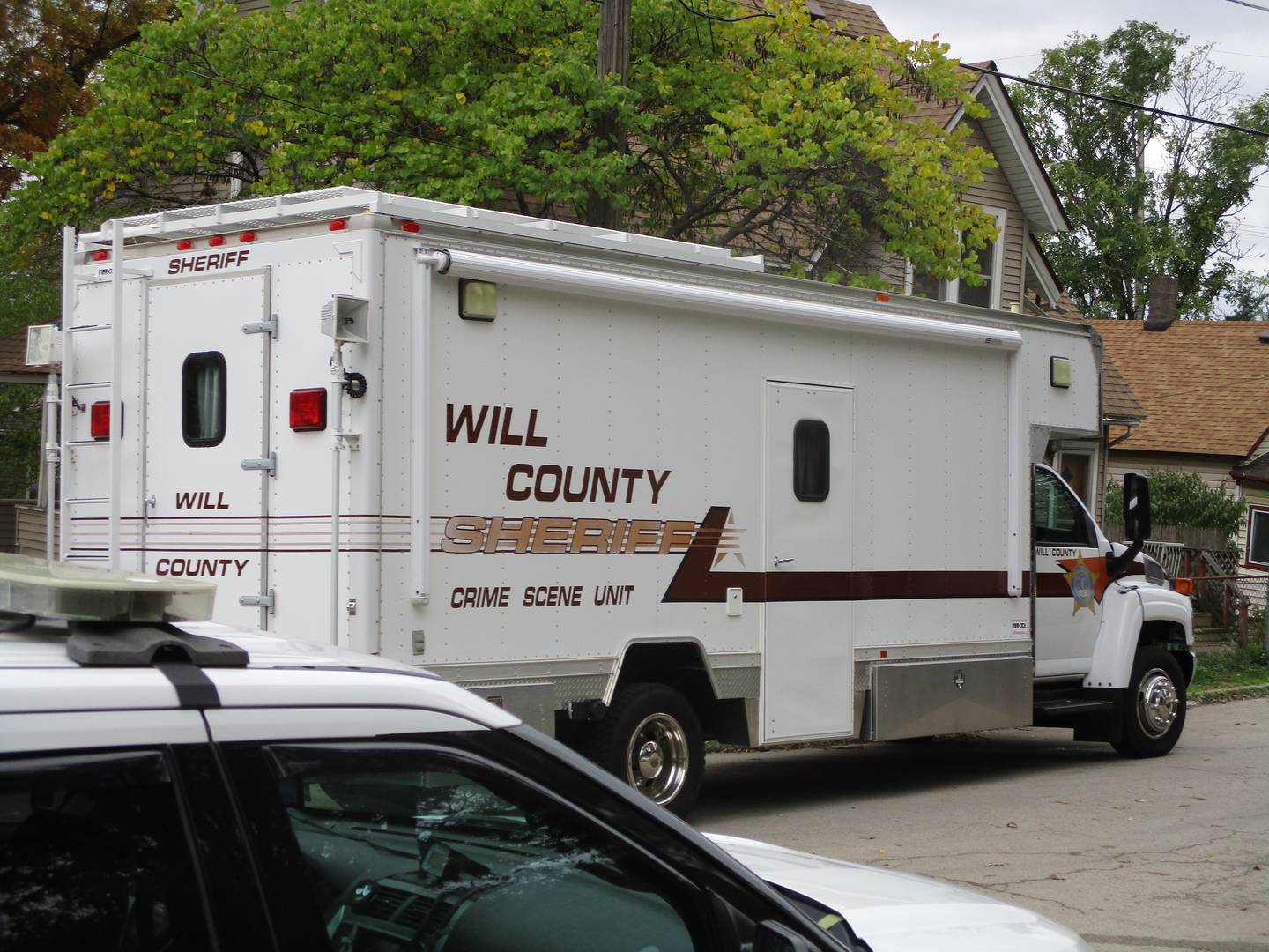 The Will County Crime Scene Unit seen on Sunday, Oct. 31, 2021 parked near the East Jackson Street house in Joliet Township where two people were killed and 10 injured during a 12:39 a.m. shooting at a Halloween party.