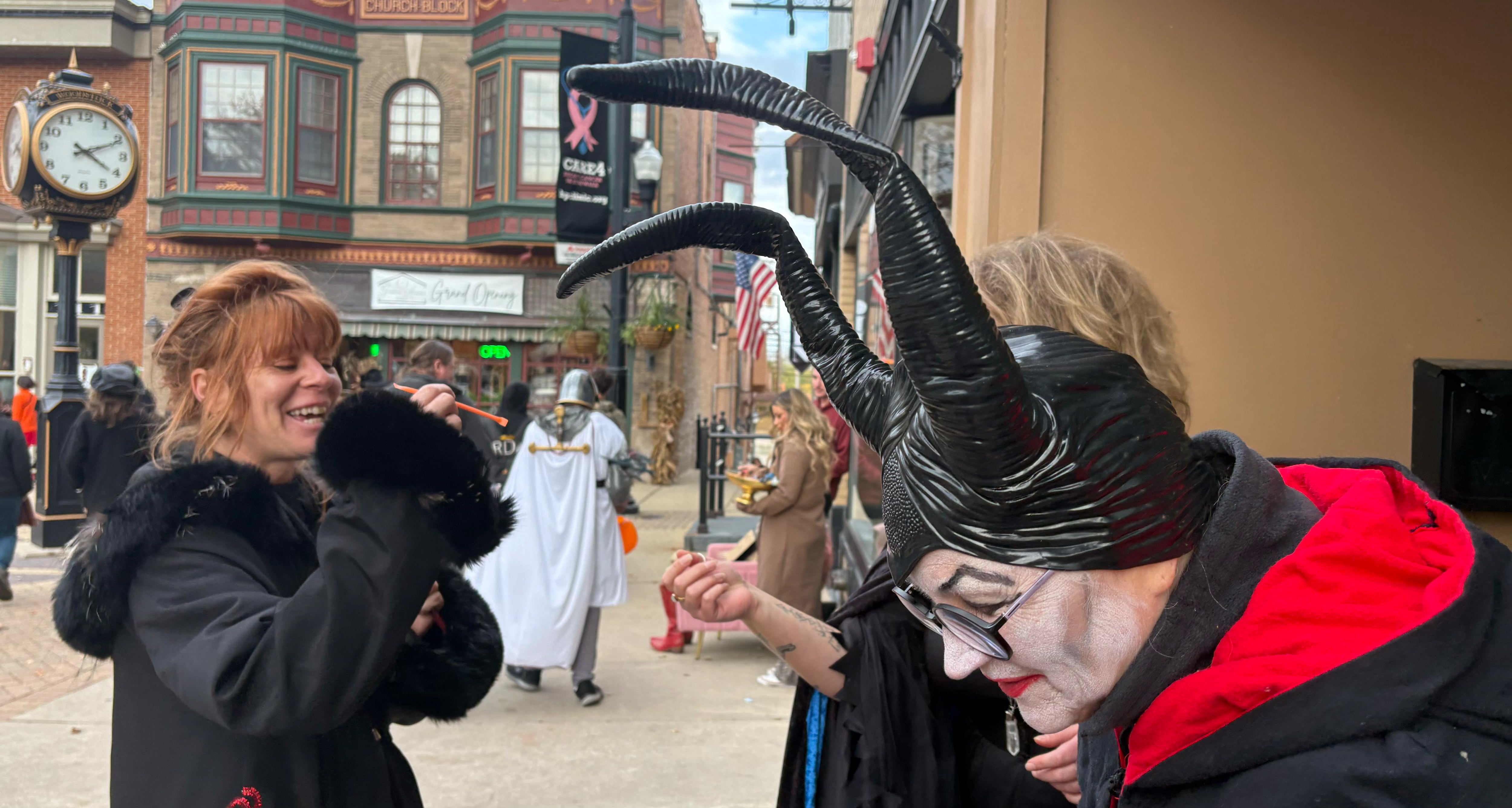 Erica Lundgren of Woodstock gets a piece of candy at Down2Earth during Halloween on the Square in Woodstock Oct. 31, 2025.