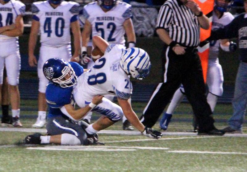 Newman’s Carter Rude tackles Princeton’s Preston Arkles during a game at Newman on Friday, Sept. 8, 2023.
