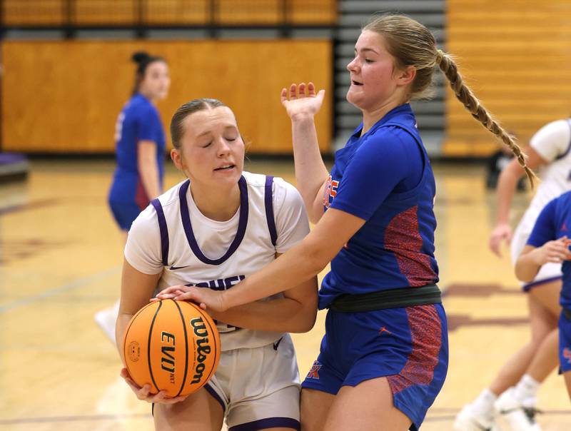 Rochelle's Reese Kissack tries to get up a shot against Genoa-Kingston's Arielle Rich during their game Monday, Dec. 15, 2025, at Rochelle High School.