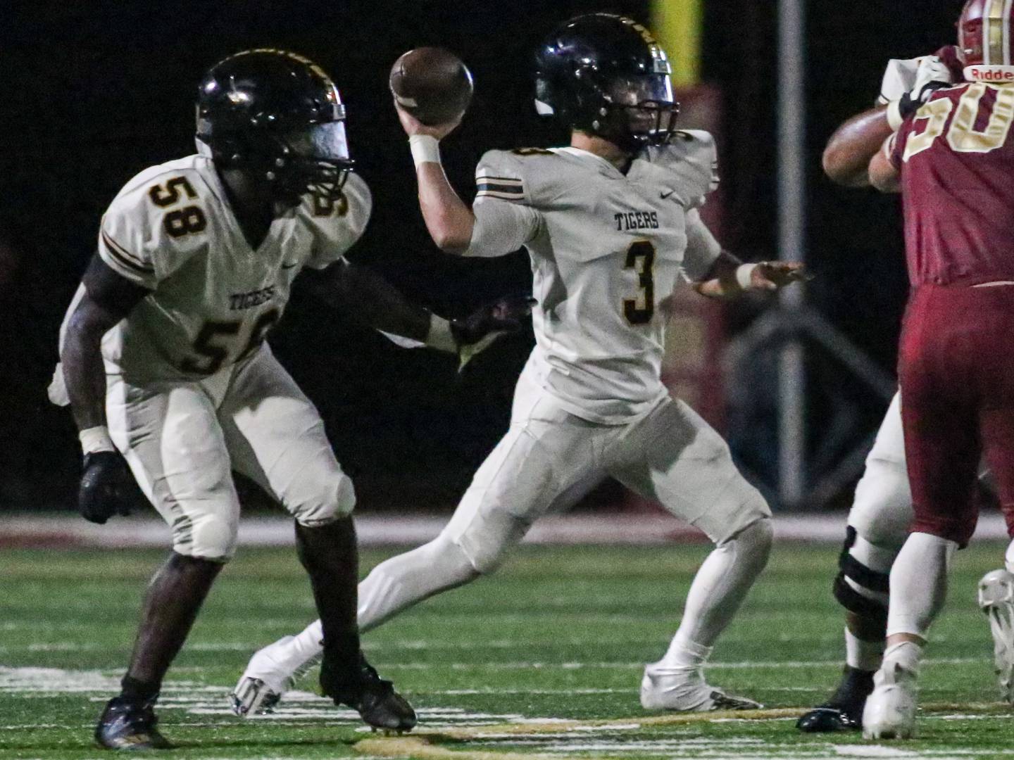 Joliet West quarterback Juan Rico (3) throws against Morris while being guarded by lineman Nyles Tate (58) earlier this season.