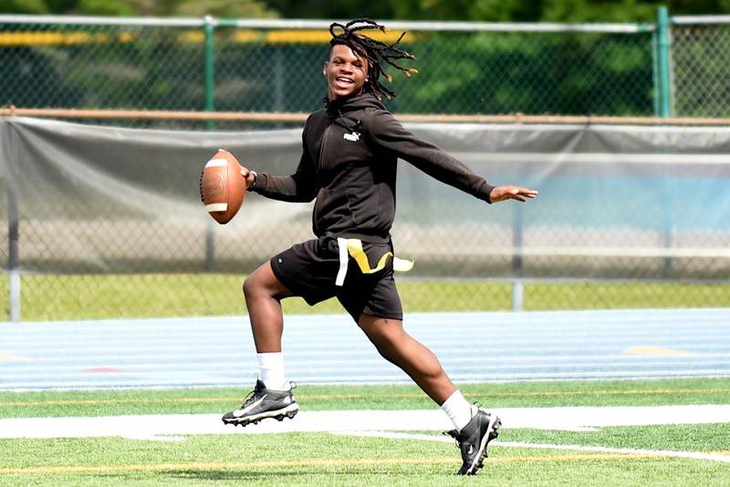 Tyion Collins, 13, of Kankakee, high steps his way into the endzone during a 7-on-7 game at the sixth annual Jonathan Ward Skills Camp at Kankakee High School Saturday, June 14, 2025.