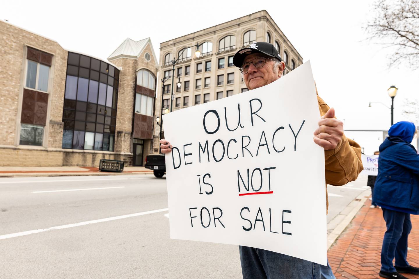 Joliet resident Bob Zimmer stands on Jefferson Street during the Hands Off protest in downtown Joliet on April 5, 2025. The rally was part of a nationwide movement on Saturday to protest policies and actions of the Trump administration and Elon Musk.