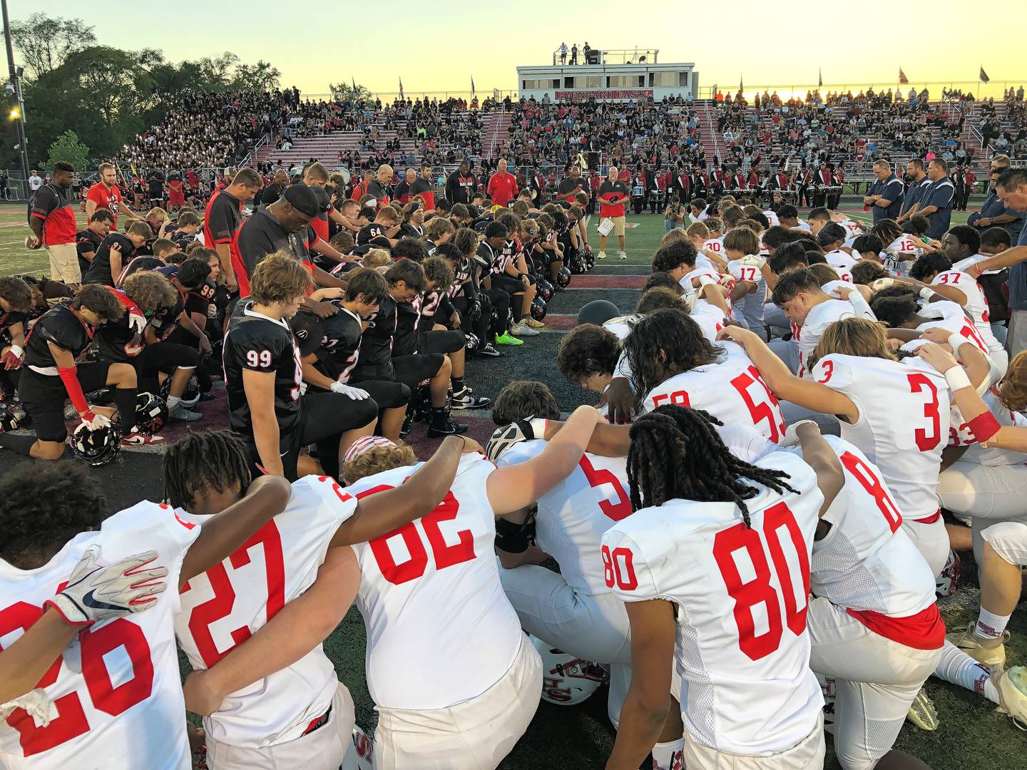 South Elgin football players (in white) join with their coaches and members of the Glenbard East football team and staff for a moment of silence for two South Elgin students who were killed in a crash Thursday. Players gathered on the 50-yard line before the start of Friday's game in Lombard.

 
South Elgin football players (in white) join with their coaches and members of the Glenbard East football team and staff for a moment of silence for two South Elgin students who were killed in a crash Thursday. Players gathered on the 50-yard line before the start of Friday's game in Lombard.