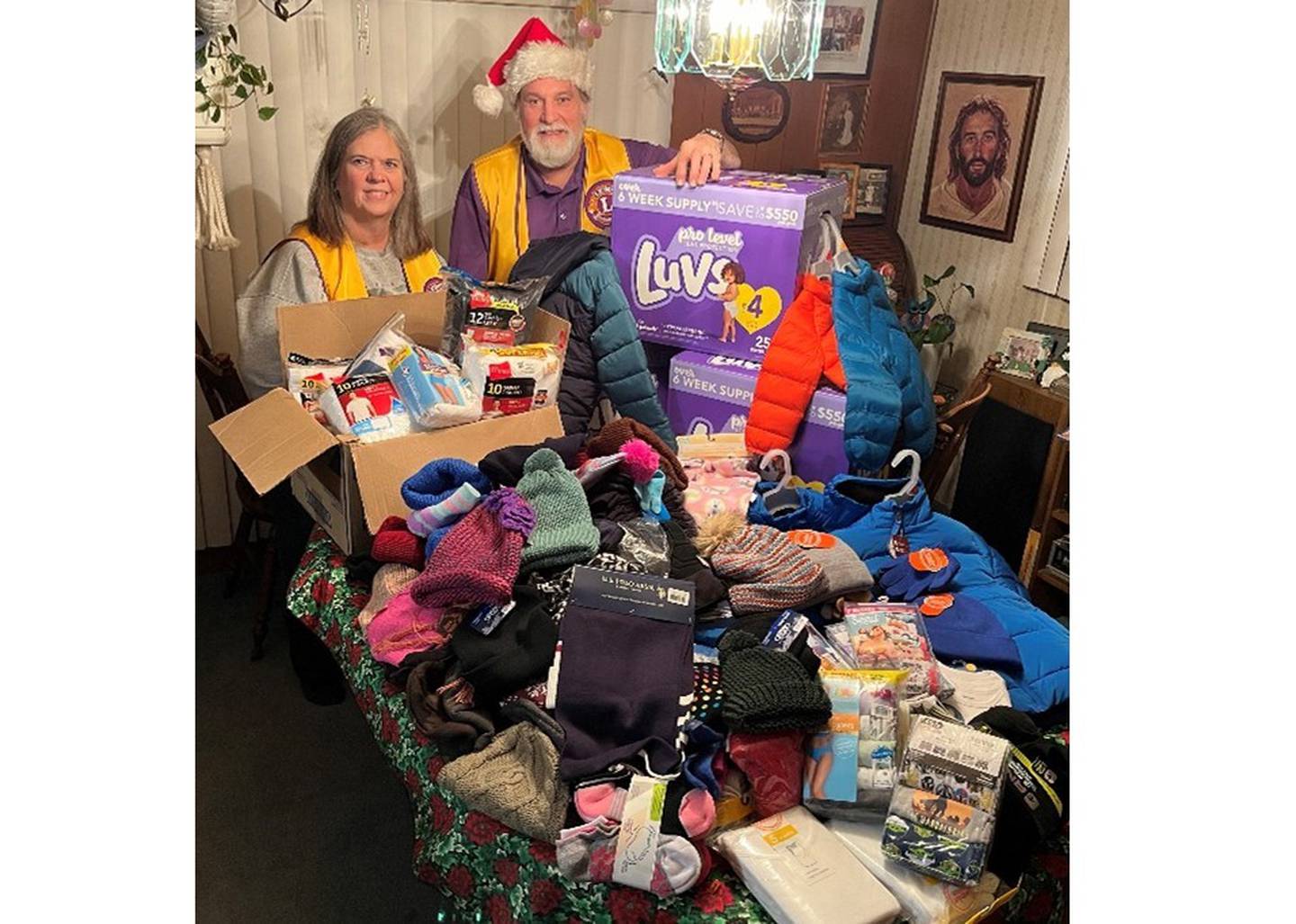 Joliet Noon Lions Bobbi and John Joseph Honiotes pose with some of the winter clothing the Joliet Noon Lions collected for Daybreak Center and Spanish Community Center, both in Joliet.