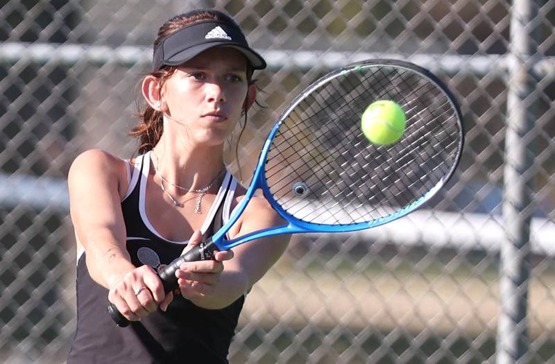 DeKalb's Aubree Judkins hits a backhand during her match against Sycamore's Elizabeth Kleckner  Monday, September 19, 2022, at Sycamore High School.