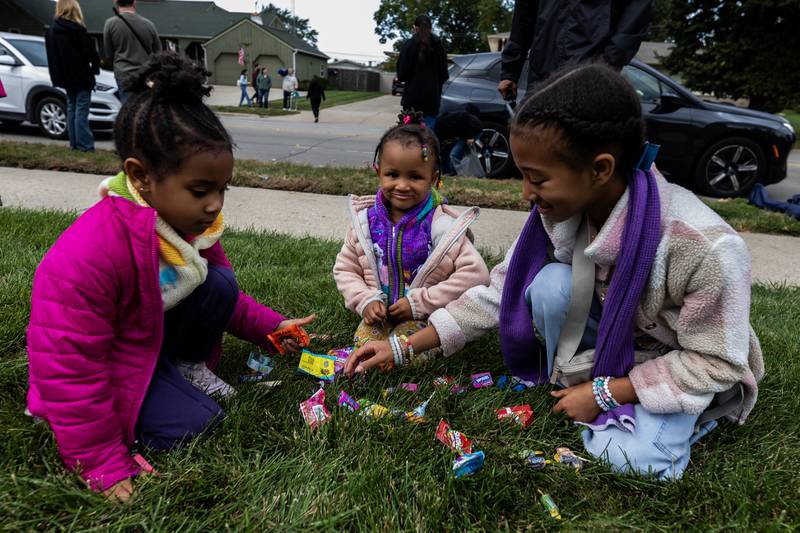 Caiya, Caria, and Caylee Crim take stock of all the candy they caught during the Joliet West homecoming parade on Oct. 10, 2025.