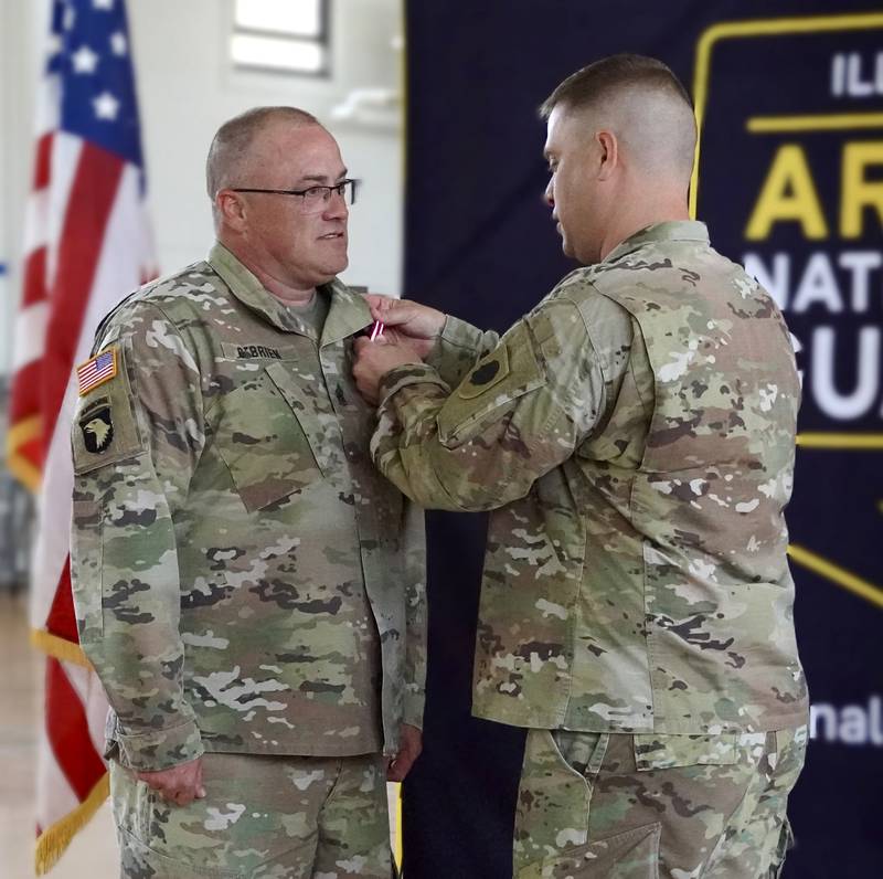 Command Sgt. Maj. Johnny O’Brien is presented the National Guard Bureau Certificate of Service by Lt. Col. Joseph Harris, Commander, Illinois Army National Guard (ILARNG) Recruiting and Retention Battalion (RRB), during a retirement ceremony June 9, 2023 at the Illinois Army National Guard armory in Dixon, Illinois. O’Brien served for 28 years in the ILARNG, most recently as the RRB’s senior enlisted leader.