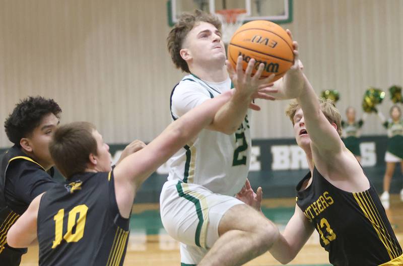 St. Bede's Gus Burr drives in the lane past Putnam County defenders Alan Castro, Traxton Mattingly and Kade Zimmerlein during the Class 1A Regional quarterfinal game on Monday, Feb. 23, 2026 at St. Bede Academy.