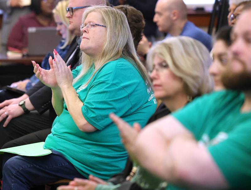 Northern Illinois University employees applaud as they listen to speakers at the NIU Board of Trustees meeting Thursday, Sept. 21, 2023, in Altgeld Hall on campus in Dekalb. Several NIU employees, represented by the American Federation of State, County and Municipal Employees, attended and spoke at the meeting seeking a fast resolution to a contract with higher pay.