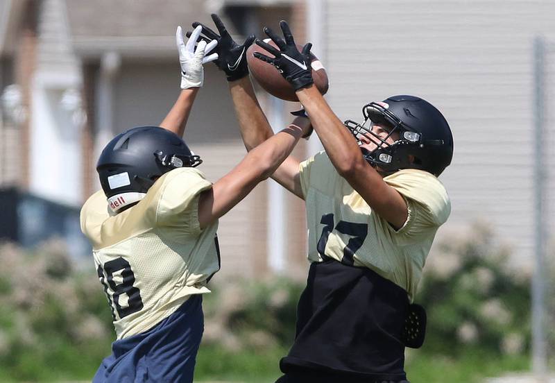 Sycamore receivers fight for the ball during a drill at practice Monday, July 17, 2023 at the school.