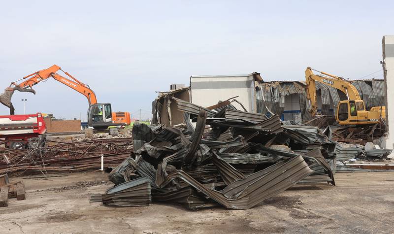 Excavators demolish a portion of the Bill Walsh Chrysler Dodge Jeep dealership on Tuesday, Feb. 17, 2026 in Peru.