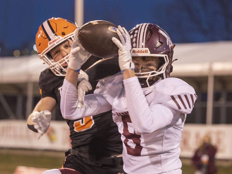 Tolono-Unity's Mason O'Neill secures a pass in the end zone against Byron’s Kole Aken Friday, Nov. 28, 2025, in the Class 3A football finals at Hancock Stadium at ISU.