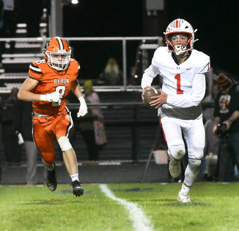 Oregon quarterback Benny Olalde (1) runs to escape Byron's Austyn Morris (8) during 3A football playoff action on Friday, Oct. 31, 2025 at the Everett Stine Stadium in Byron.