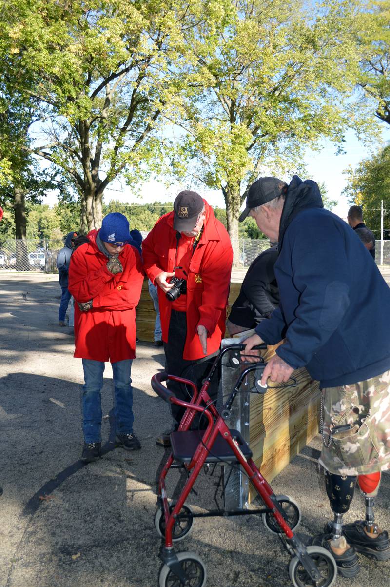 Gab Buelvas, 17, of Dixon, left, and his grandfather, Steven Lange, right, listen to Boy Scout Troop 85 Committee Chairperson Thomas Halla, center, as Halla explains a potential challenge Buelvas needs to address in the construction of a gaga ball pit for Vaile Park on Saturday, Oct. 7, 2023. Buelvas led a group of about 15 volunteers in building the gaga ball pit as his Eagle Scout project.