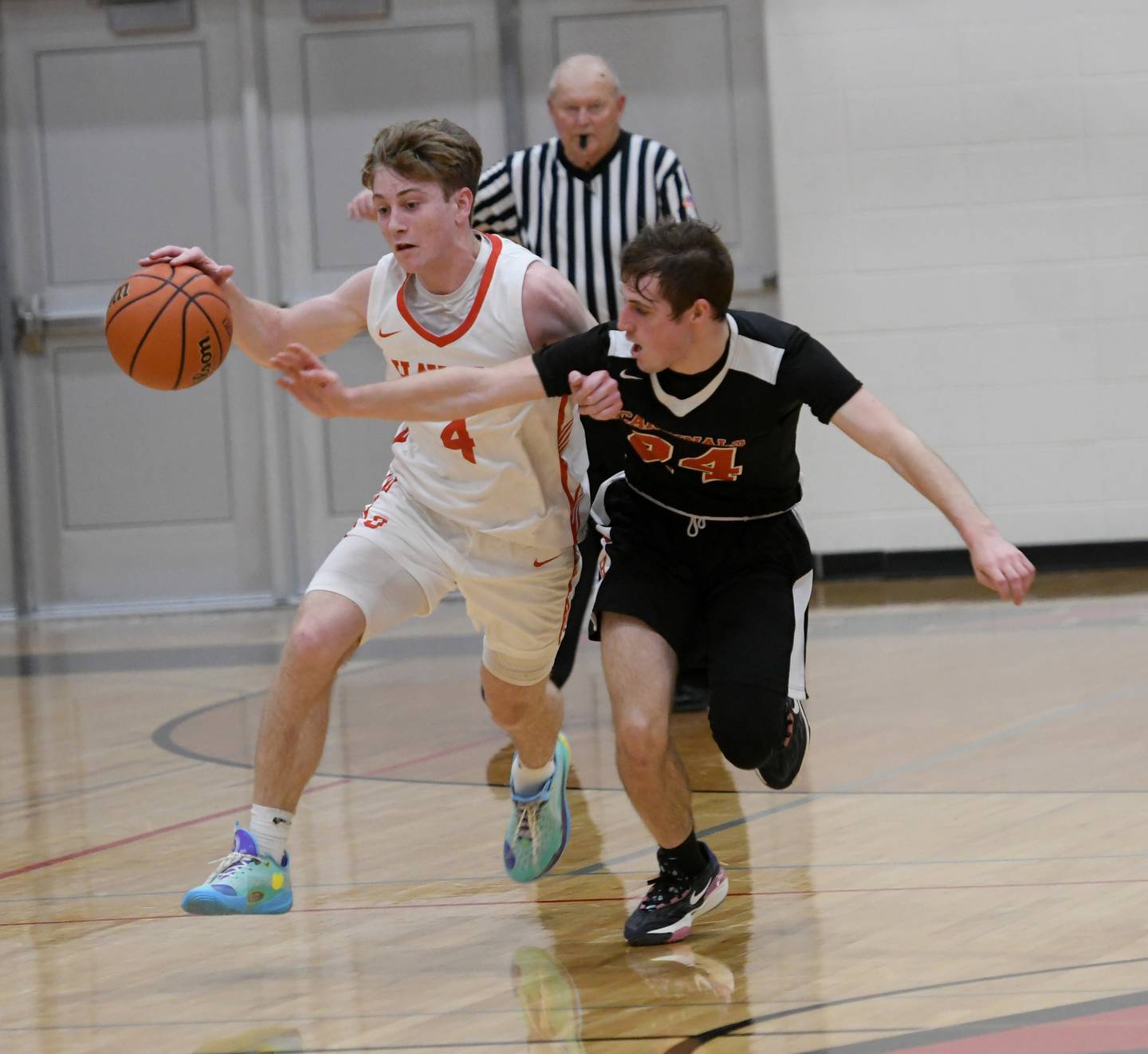 Oregon's Jameson Caposey dribbles as Forreston's Payton Encheff reaches in to try and steal the ball during Saturday action at the 61st Forreston Holiday Tournament.