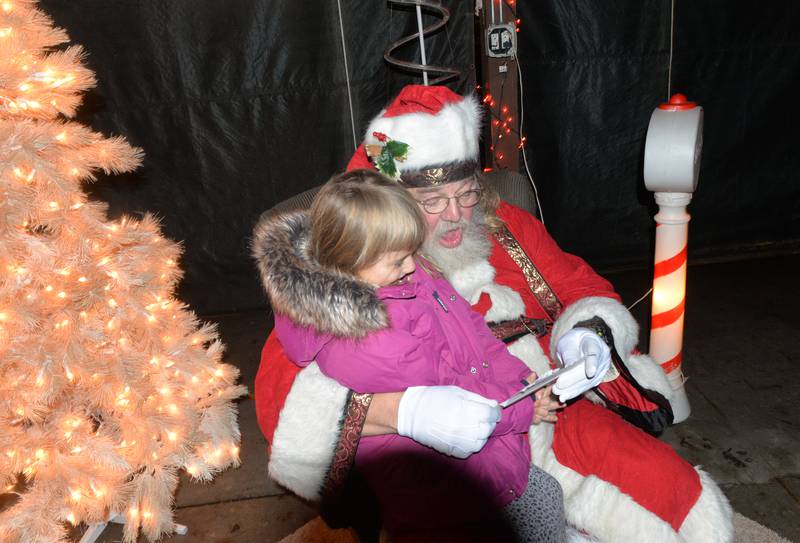 Santa reads Fae Zettle's list as he visits with the Forreston six-year-old during Christmas in the Country on Friday, Dec. 1, 2023. Santa and Mrs. Claus visited with kids in the shelter at Memorial Park during the evening event.