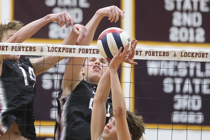 Lockport’s Noah Bluhm knock down the ball against Joliet West on Tuesday, March 31, 2026 in Joliet.