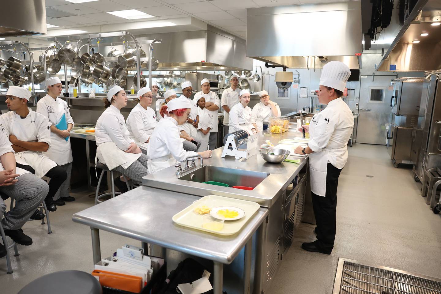 Students at Joliet Junior College watch as Chef Katey Sopko goes over safe cutting techniques at the City Center Campus. Monday, Aug. 29, 2022, in Joliet.