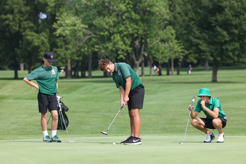 Coal City's McKale Perino, center, putts as teammate Kory Lovell, left, and Bishop McNamara's Griffin Meier look on during the Bill Breeden All-Area Classic at the Kankakee Elks on Monday, Aug. 18, 2025.