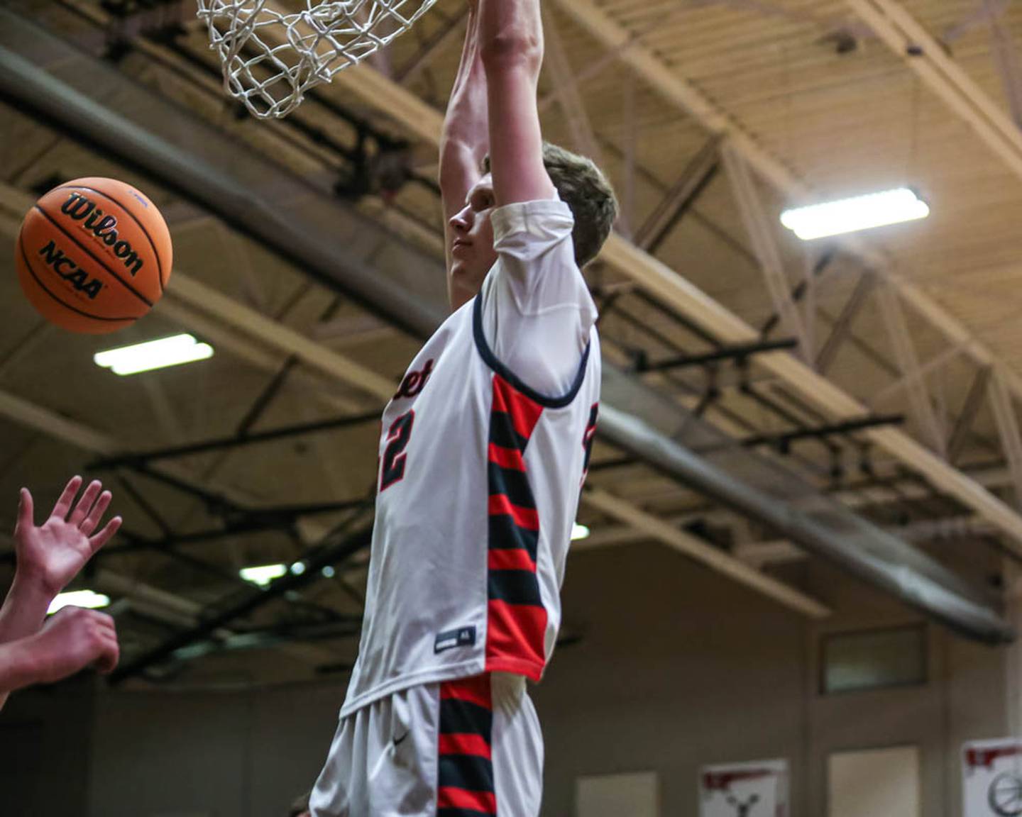 Benet's Colin Stack (42) dunks off of handoff underneath the basket during their Class 4A Bolingbrook Sectional semifinal basketball game between Yorkville at Benet, March 3, 2026 in Bolingbrook.