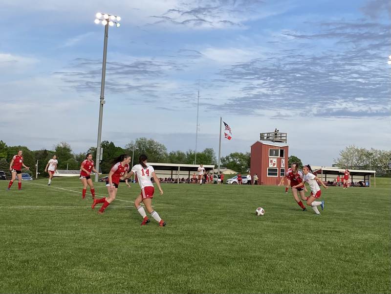 Ottawa's Gabi Krueger (18) races Metamora's Shealyn Terry to a drop pass from Kalie Anderson (14) on Tuesday, May 17, 2022, during their Class 2A Metamora Regional semifinal.