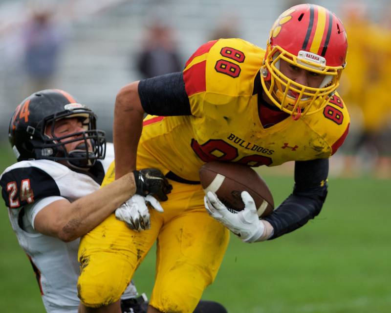 Batavia's Glenn Albanse carries the ball as St. Charles East's Nicholas Sherman looks for the stop on Saturday in Batavia.