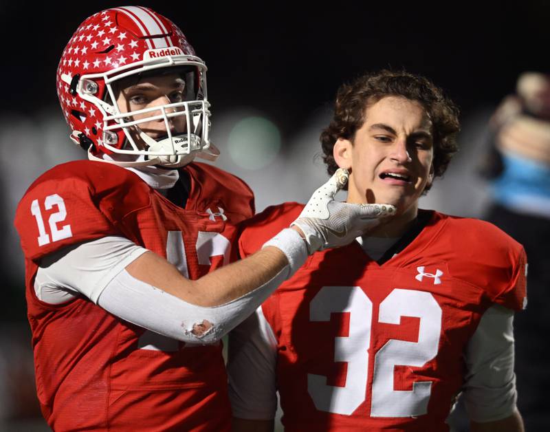 Naperville Central’s Garrett Nichols, left, tries to comfort Gavin Ellison after their team’s 20-15 loss to York during the Class 8A football state semifinal on Saturday, Nov. 23, 2024 in Naperville.