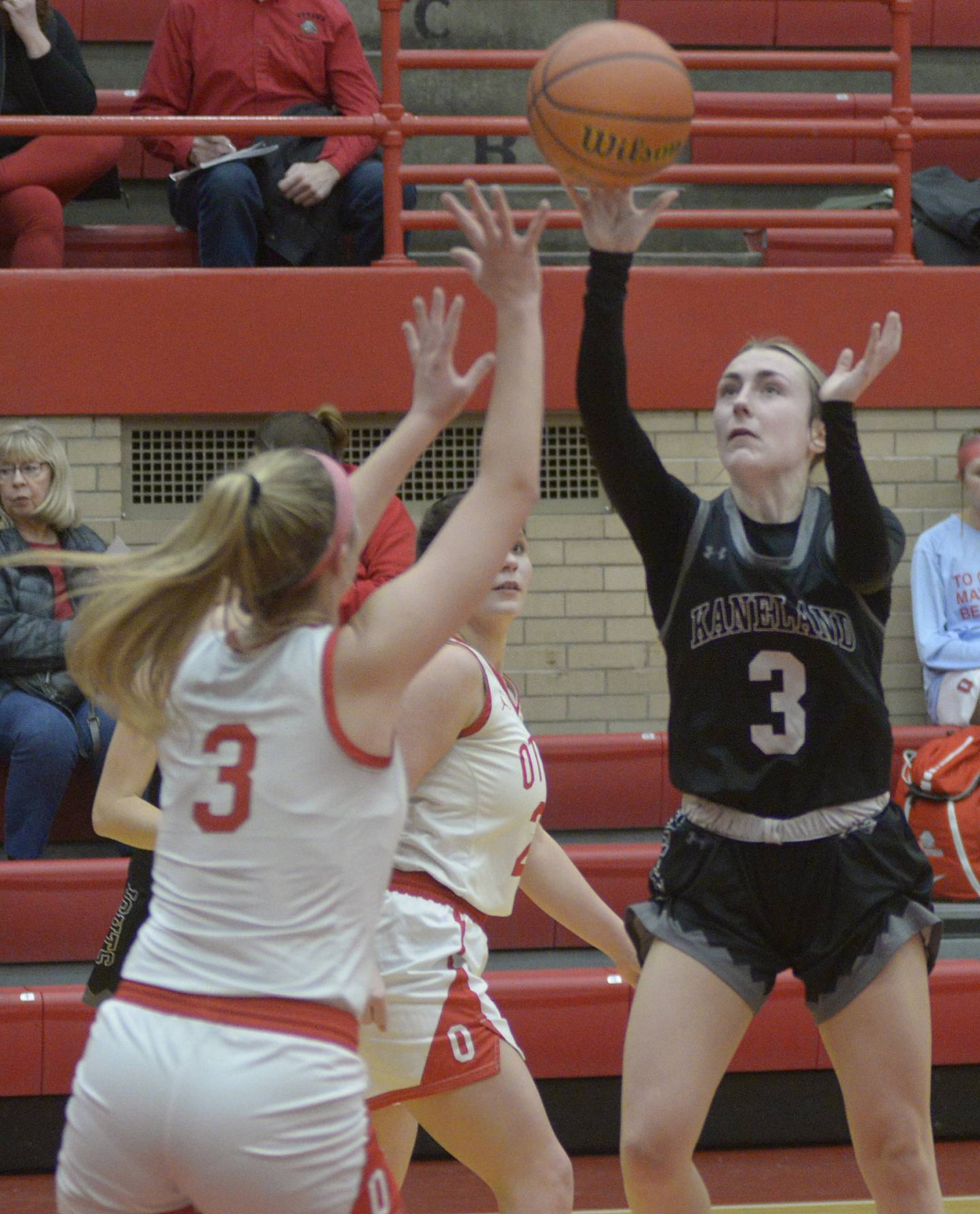 Kaneland’s Alexis Schuyler gets a shot away over the block attempt by Ottawa’s Skylar Dorsey in the 2nd quarter Wednesday at Ottawa.