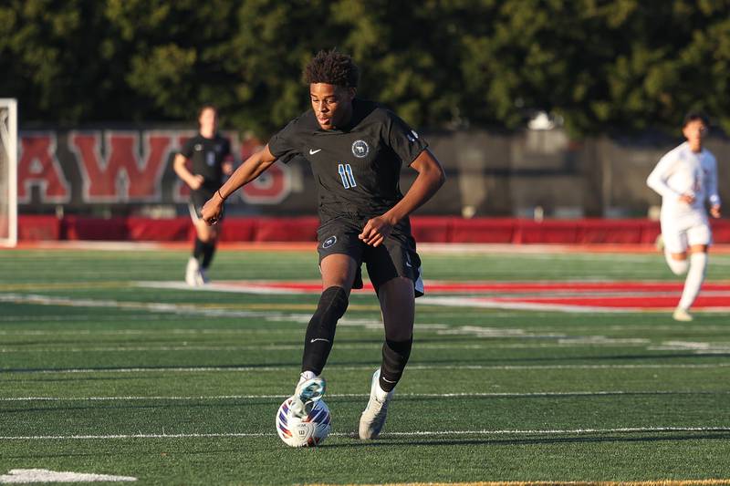 Lincoln-Way East’s Kamden Williams sets the ball up before scoring against Homewood-Flossmoor in the Class 3A Marist Regional semifinal on Wednesday, Oct. 23, 2024 in Chicago.