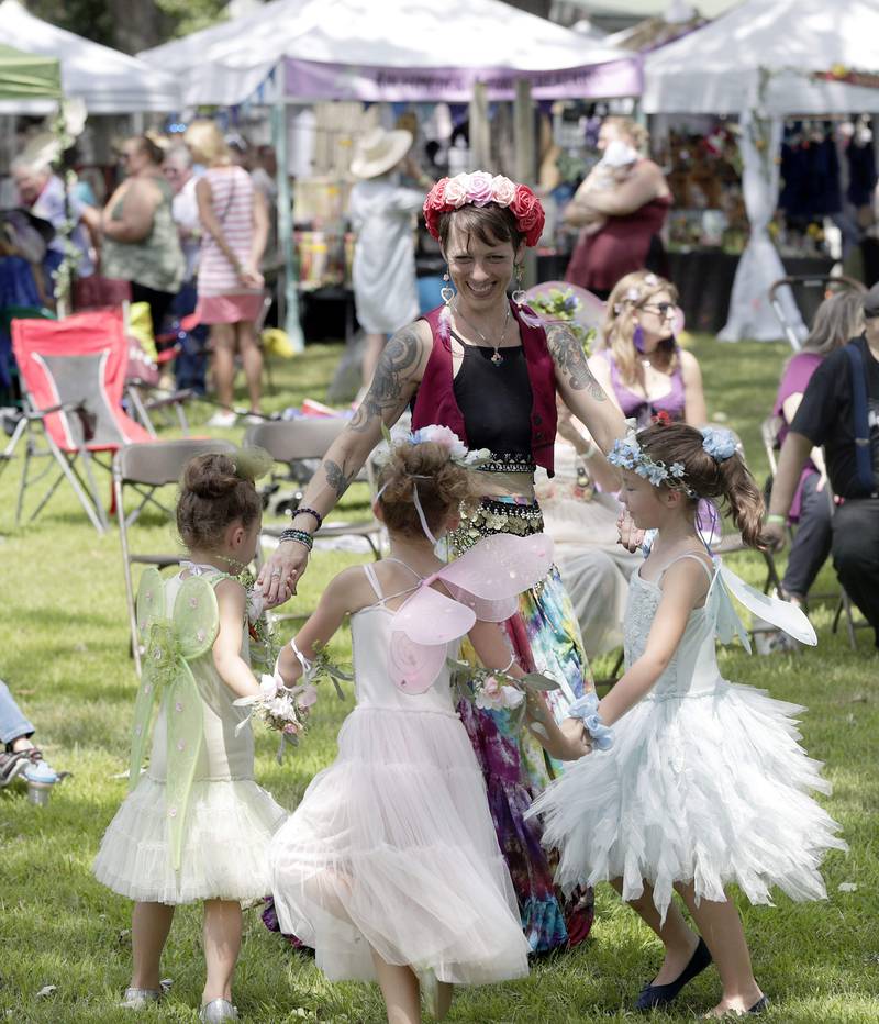 People dance and twirl as Nazario Chickpeazio performs during the World of Faeries Festival Saturday August 6, 2022 at Vasa Park in South Elgin.