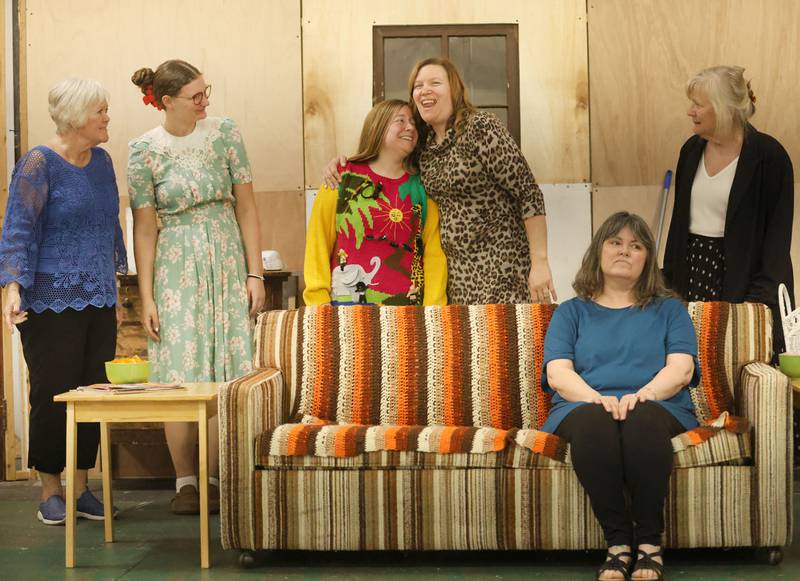 (From left) Clairee played by Deborah Puetz, Annelle played by Emma Kay Gaspardo, Shelby played by Deanne Crook, Truvy played by Christine Gaspardo,  M’Lynn played by Kelli Landon and Ouiser played by  Cyndy Bruch act out a scene during a rehearsal of Steel Magnolias on Tuesday, April 21, 2026 at St John XXIII Community Center in Henry. The River Valley Players will perform Steel Magnolias April 30 – May 3. Steel Magnolias is a perfect mix of humor and heart, following six women as they navigate life, love, and loss together.