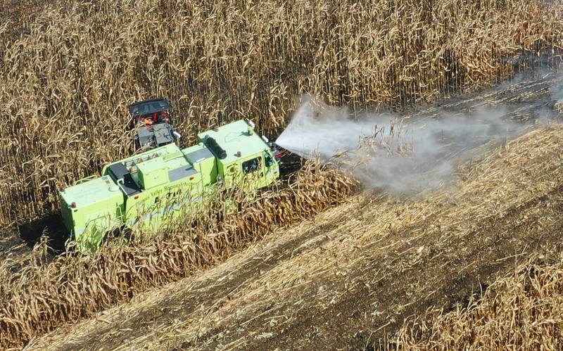 Peru firefighters use their Illinois Valley Regional Airport fire truck to extinguish a brushfire in a corn field on Wednesday, Oct. 9, 2024 along Interstate 80 in the eastbound lane near mile post 65 in Bureau County.  A MABAS box alarm was sent out around 11:45 a.m. and upgraded to a fourth-alarm. Interstate 80 was shut down in the Eastbound lane while firefighters doused the flames. Fire companies from Utica, Oglesby, Ladd, Bureau, Hennepin, Peru, La Salle, Spring Valley and others responded to the scene.