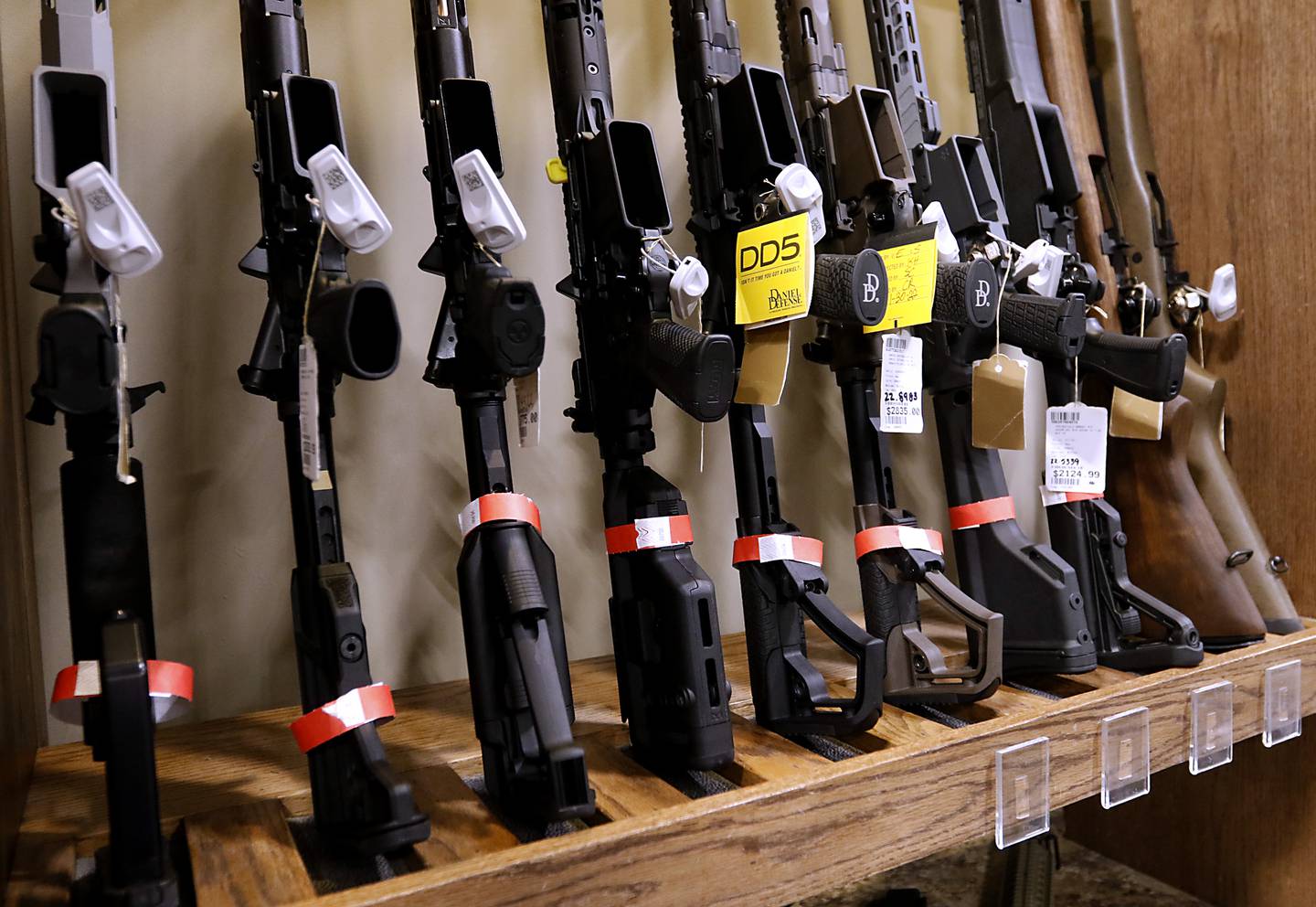 Red tagged firearms that can no longer sold at Second Amendment Sports, in McHenry, Wednesday Jan. 11, 2023, after a new gun law restricting a number of firearms and attachments and limiting ammunition was signed into law Tuesday night by Gov. JB Pritzker. The bill, along with requiring registration for such guns if already owned and enhancing gun restraining orders, hits at semiautomatic weapons.