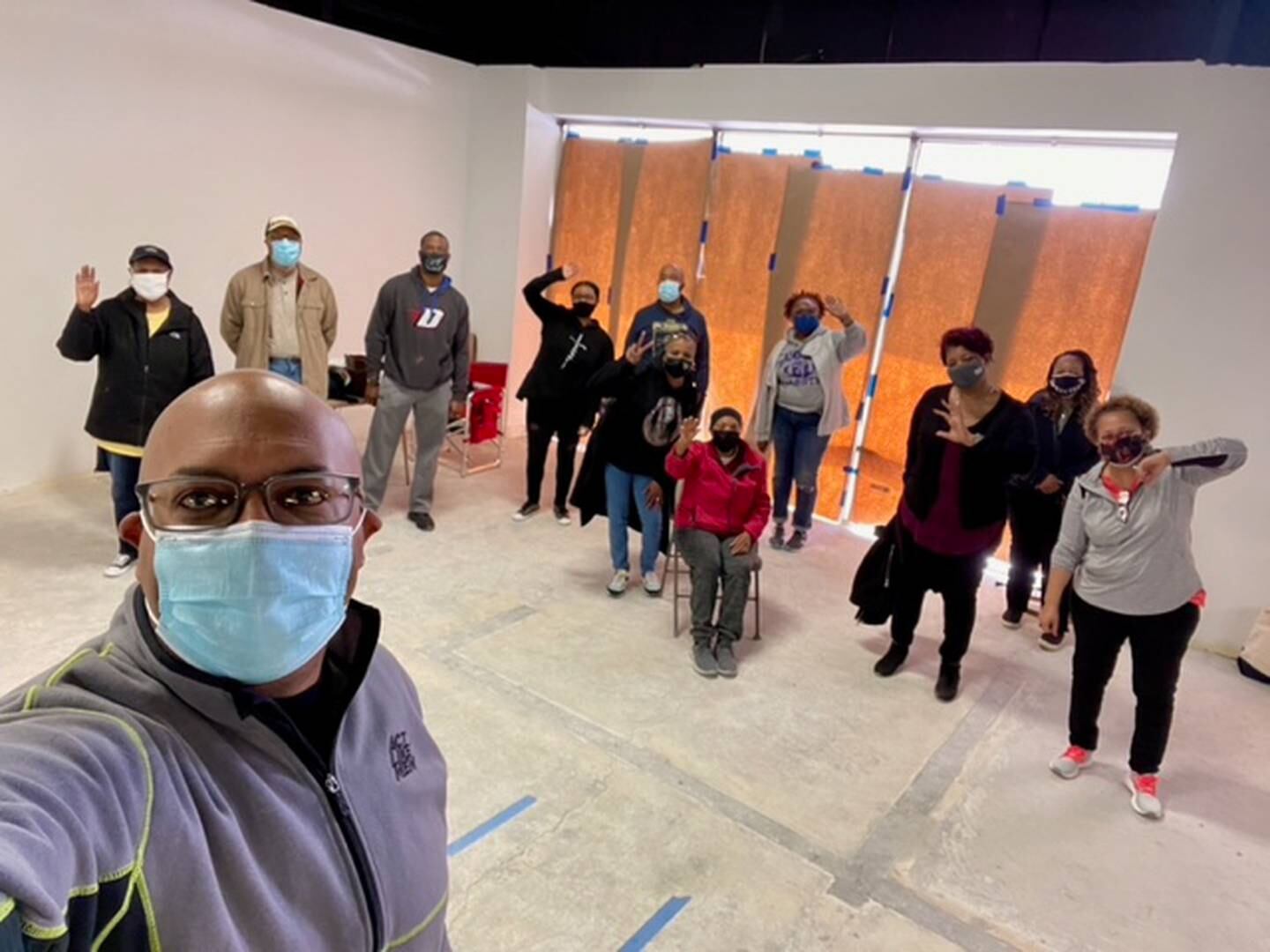 During The Way Church of Joliet's first prayer service in its new space on Theodore Street in Joliet, members wrote scripture verses on the bare floor. Rev. Edward L. Winfrey Jr., church pastor, is pictured in the foreground.