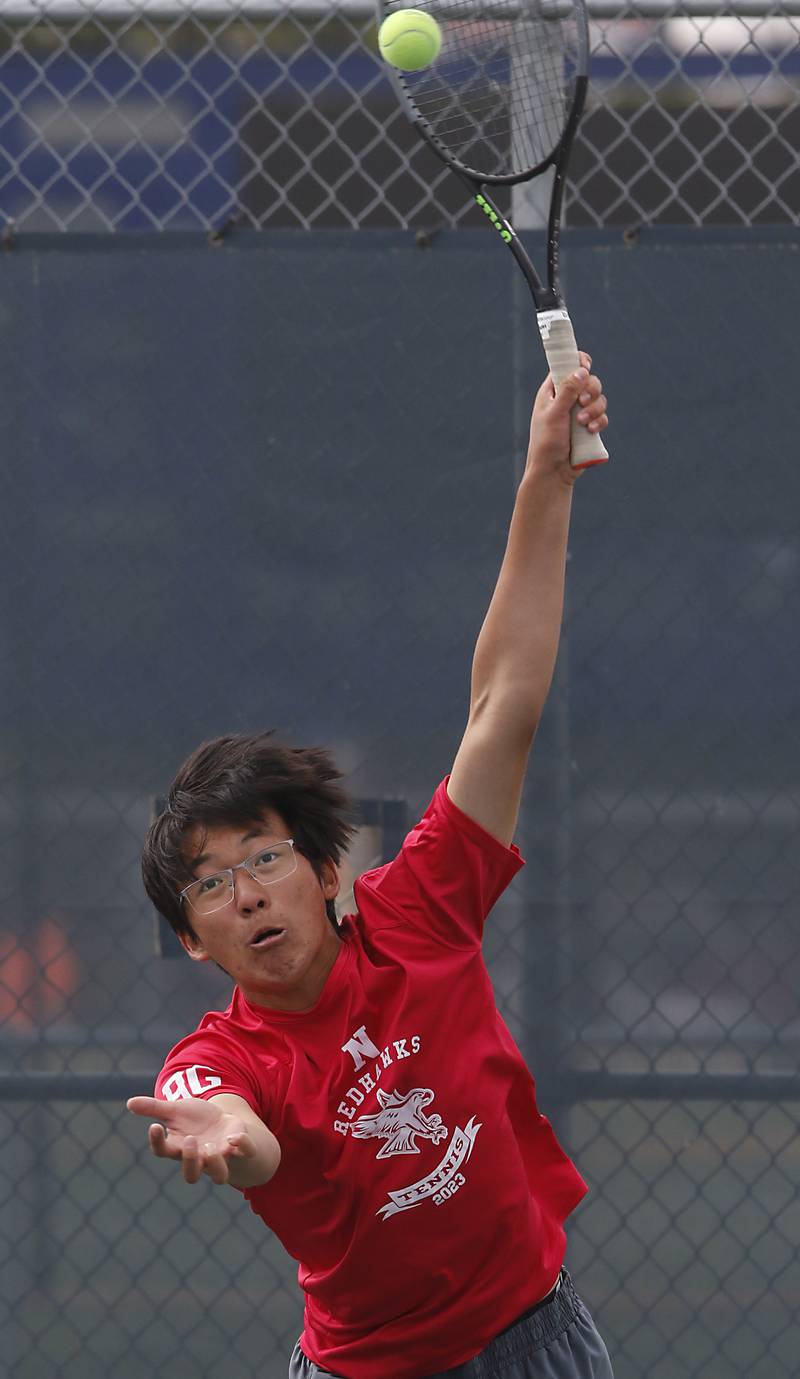 Naperville Central’s Jeremy Zhao serves the ball during an IHSA 2A boys doubles tennis match Thursday, May 25, 2023, at Buffalo Grove High School.