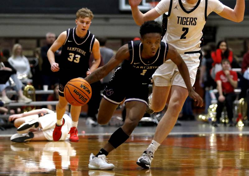 Hampshire's Chayse Gray pushes the ball up the court abasing Crystal Lake Central's Danny Spychala during a Fox Valley Conference basketball game on Friday, Feb. 7, 2025, at Crystal Lake Central High School.