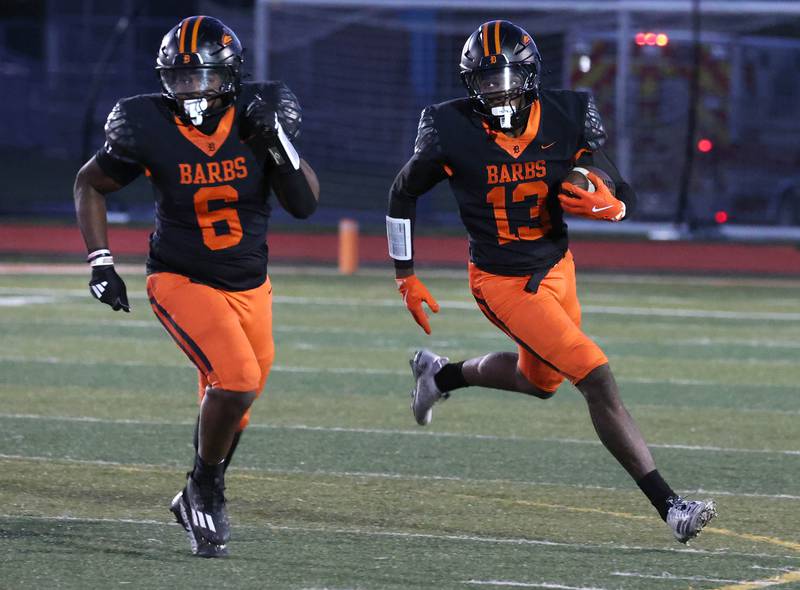 DeKalb's Davon Grant follows teammate Travis Moore to the outside of the Phillips defense on a sweep for a big gain Friday, Sept. 5, 2025, during their game at DeKalb High School.