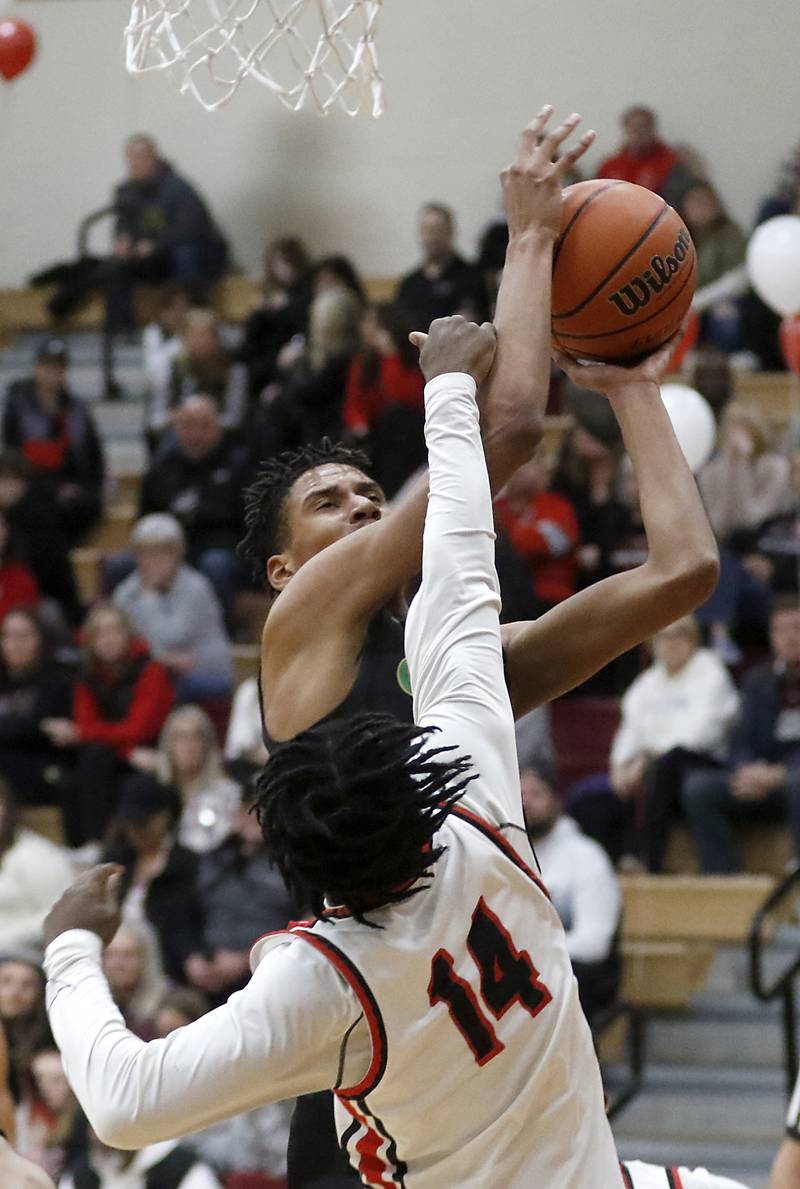 Crystal Lake South's Christian Rohde is fouled by Huntley's Sheldon Bonsu as Rohde  shots the ball during a Fox Valley Conference boys basketball game Tuesday, Feb.6, 2024, at Huntley High School.