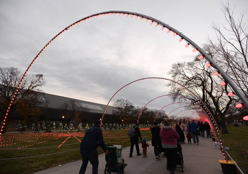 Brookfield Zoo attendees walk through a light tunnel during their Holiday event held Saturday Nov 26, 2022.