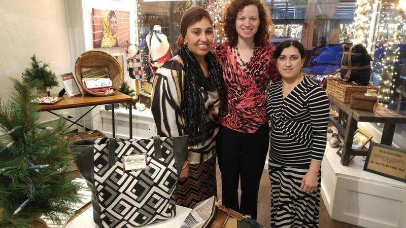 Re:new artisan Fatma Buho (left), Executive Director Susan Tripi DeLano and artisan Kamila Gaydarova stand in the showroom of Re:new's new location at 483 N. Main St. in downtown Glen Ellyn.