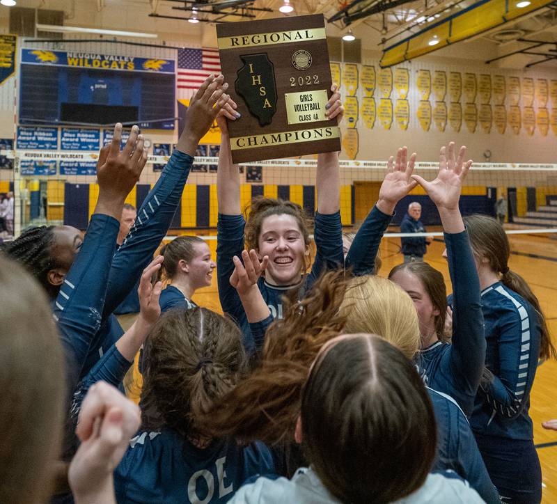 Oswego East's Samantha Trujillo (6) raises the 4A regional championship plaque in celebration after defeating Neuqua Valley at Neuqua Valley High School in Naperville on Thursday, Oct 27, 2022.