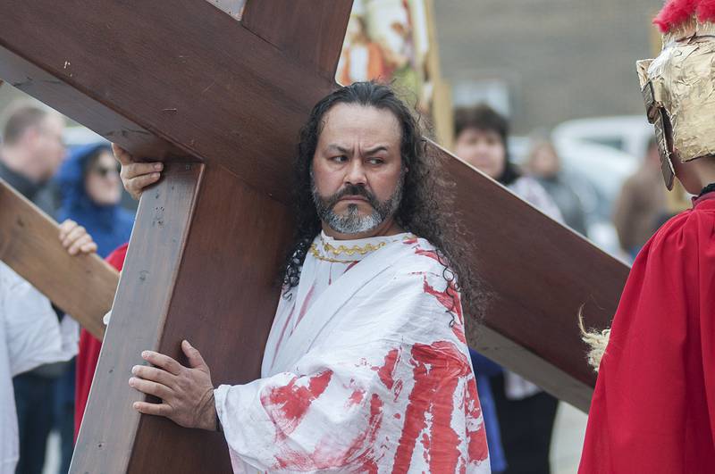 Felix Romo beings his journey playing the part of Jesus on Friday, April 15, 2022 during the retelling of the “stations of the cross” by St. Mary’s parish in Sterling.