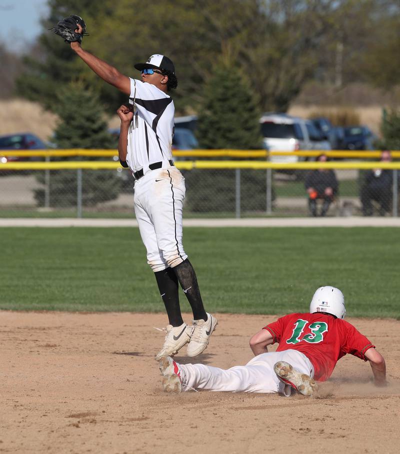 La Salle-Peru's Braylin Bond slides in safely to second as Sycamore's Tyler Townsend has to jump for the high throw Wednesday, April 23, 2025, during their game at the Sycamore Community Sports Complex.