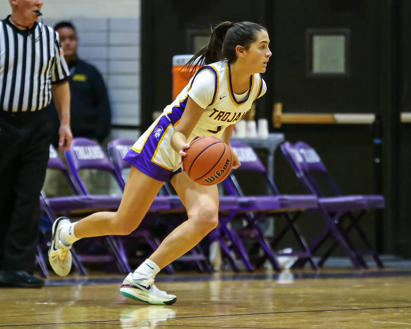 Downers Grove North's Campbell Thulin (5) drives on Downers Grove South's Hayven Harden (4) during girls basketball game between Downers Grove South at Downers Grove North. Dec 16, 2023.