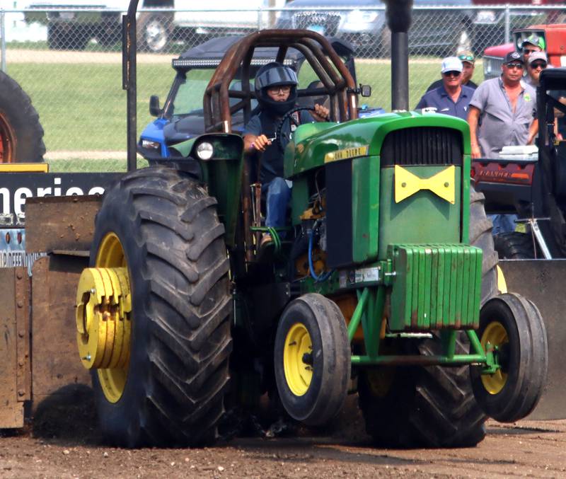 A driver navigates a wheelie during tractor pulls on the final day of the 2025 McHenry County Fair in Woodstock on Sunday, August 3, 2025.