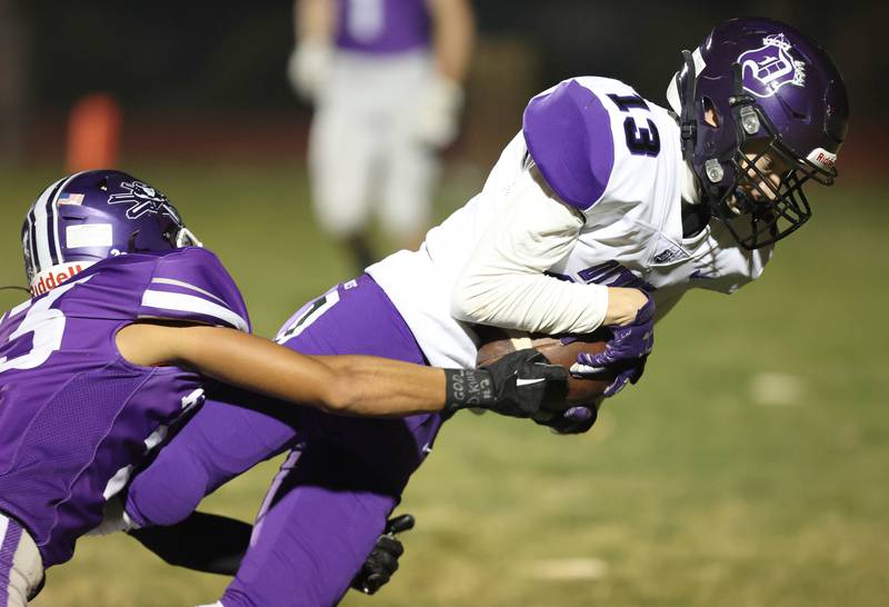 Dixon’s Cullen Shaner carries a Rochelle defender into the end zone for a touchdown during their first round playoff game Friday, Oct. 28, 2022, at Rochelle High School.