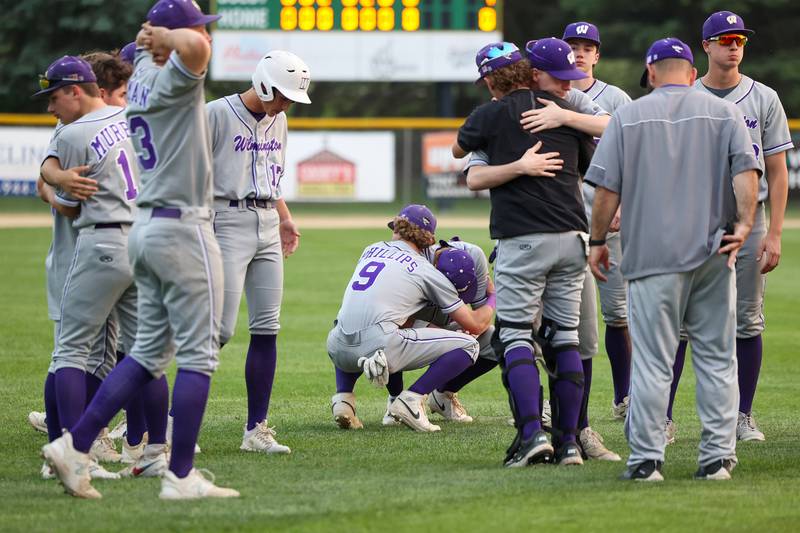 Wilmington's Bobby Phillips (9), at center, comforts senior teammate Lucas Rink following the Wildcats' 4-0 loss to Eureka in the IHSA Class 2A Geneseo Super-Sectional on Monday, June 2, 2025.