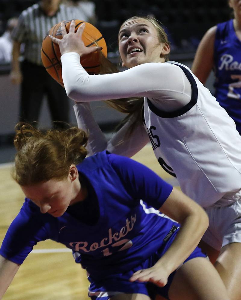 Cary-Grove's Alivia Nielsen shoots the ball over a falling Burlington Central's Maggie Shell after Shell tried to block the shot during a Fox Valley Conference basketball game  on Tuesday, Jan. 14, 2025, at Now Arena in Hoffman Estates.
