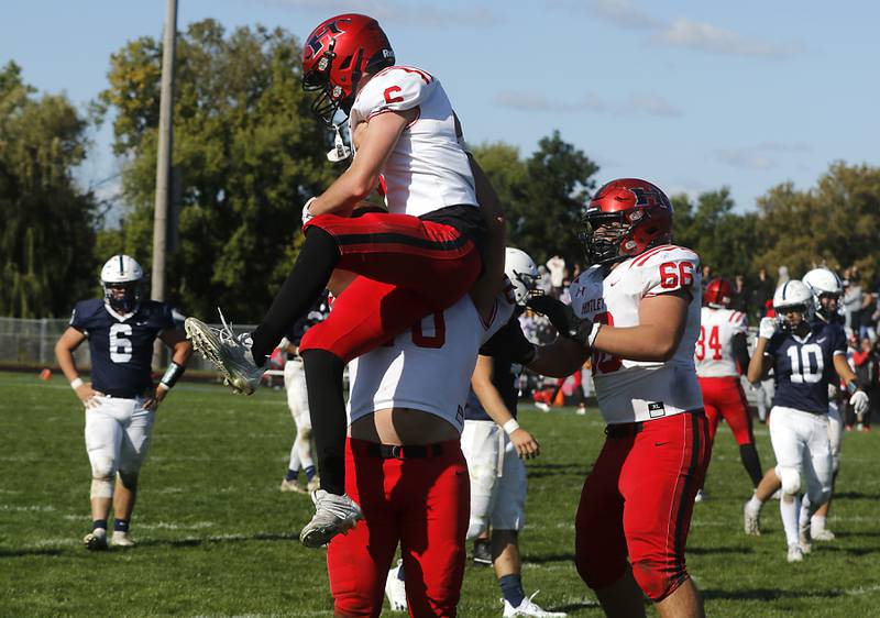 Huntley's Jacob Witt and his teammates celebrate his touchdown at the end of the fourth quarter during a Fox Valley Conference football game on Saturday, Oct. 7, 2023, at Cary-Grove High School.